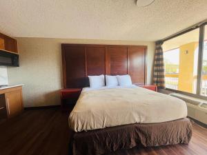 a bedroom with a large bed with a large window at North Villa extended stay in Houston