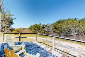 two chairs sitting on the deck of a house at North Truro Bayside Gem in Truro