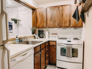 a kitchen with a sink and a stove at 73SW - WiFi - F P - WithD - Sleeps 6 home in Glacier