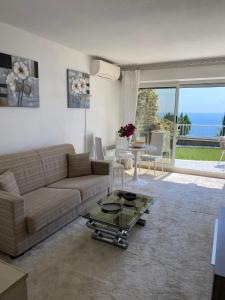 a living room with a couch and a table at Cap d.Azur in Roquebrune-Cap-Martin