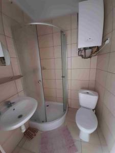 a bathroom with a shower and a toilet and a sink at Kraków Hostel in Krakow