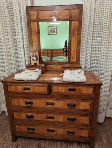 a dresser with a mirror on top of it at Villa Vittorio in Forno di Zoldo