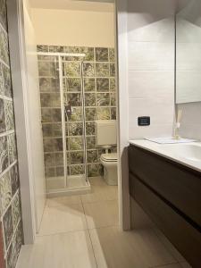 a bathroom with a shower and a sink and a toilet at SUB 14 Suite Apartment - Vietato Fumare in Reggio Emilia