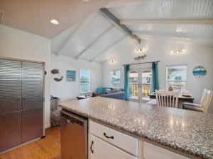 a kitchen with a counter top and a living room at Amigo Bay in Galveston