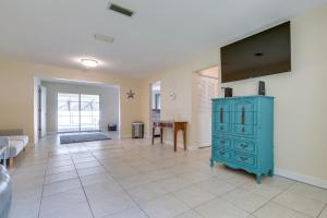 a living room with a blue cabinet on a tiled floor at Citrus Springs Vacation Rental with Private Pool! in Citrus Springs