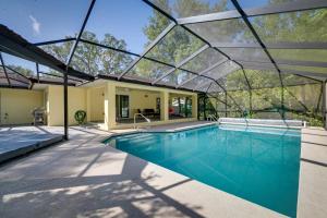 an indoor swimming pool with a glass roof at Citrus Springs Vacation Rental with Private Pool! in Citrus Springs