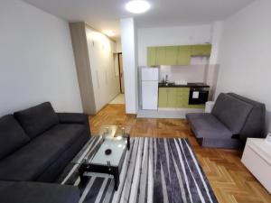 a living room with a couch and a table at Apartman MiS Trebinje in Trebinje