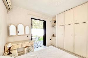 a bedroom with a bed and a large window at Nemesis House Elani Beach in Elani