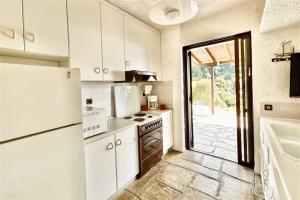 a kitchen with white appliances and a door to a patio at Nemesis House Elani Beach in Elani