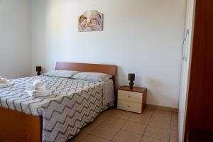 Postel nebo postele na pokoji v ubytování B&B L'Uliveto Rooms & Pool