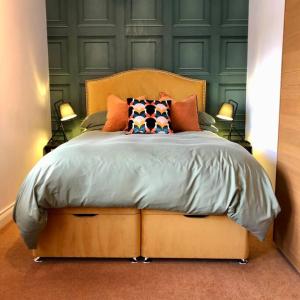 a bedroom with a large bed with two lamps at Bank Building Apartments in Barnoldswick