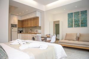 a kitchen and a living room with two beds in a room at SM Luxury Penthouse Corfu in Ágios Rókkos