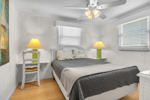 a bedroom with a bed and a ceiling fan at Sunkissed 2 by Oak Island Accommodations in Oak Island