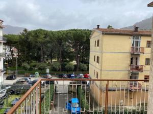 a balcony with a view of a parking lot with cars at B&G large and bright apartment in Cava deʼ Tirreni