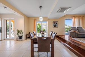 a dining room and living room with a table and chairs at Apartment Anchor in Šibenik +37 photos