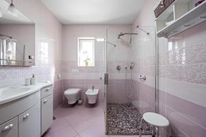 a bathroom with a shower and a toilet and a sink at Apartment Anchor in Šibenik