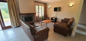 a living room with two couches and a fireplace at 3-Bedroom House, Greenway Woods, White River in White River