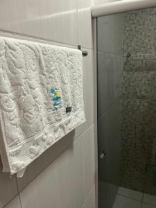 a towel hanging on a wall in a bathroom at Casa da Tetê in Fernando de Noronha