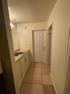 a small kitchen with a sink and a door at Crown Inn & Suites in Spring Valley