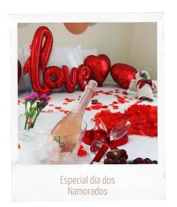 a picture of a valentines table with a bottle of champagne at Pousada Balneário Camboriú in Balneário Camboriú