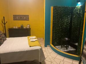 a bedroom with a bed with a yellow blanket and a window at VILLA OASIS in Puerto Vallarta
