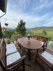 a patio with a table and chairs and a view at Elia House in Vatopedi