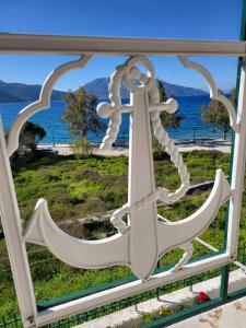 an anchor in a window with a view of the water at Captain's panoramic sea view in Sami