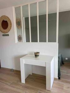 uma mesa branca num quarto com um espelho em Cocon Méditerranéen em Cagnes-sur-Mer