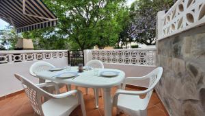 una mesa blanca y sillas en un patio en El encanto de Aguadulce, en Aguadulce