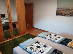 a room with two beds and a mirror at Apartment - Ferienwohnung 1 Treffen am Ossiachersee in Treffen