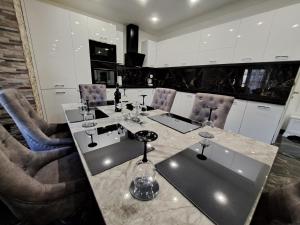 a kitchen with a table with wine glasses on it at Apartment Monaco in Rijeka