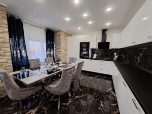 a kitchen with a table and chairs and a counter at Apartment Monaco in Rijeka