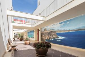 a lobby with a large mural of the ocean at Casa Yerida in El Cotillo
