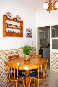 a dining room with a wooden table and chairs at Casa Maria in Albufeira