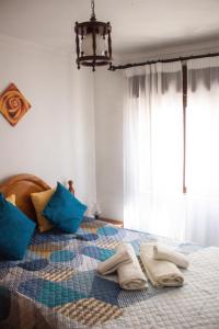 a bedroom with a bed with towels on it at Casa Maria in Albufeira