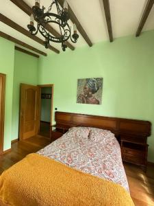 a bedroom with a bed and a chandelier at Lar do Pilís in Ourense +51 photos