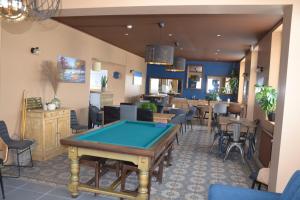 a restaurant with a pool table in the middle at L'Auberge de Vauclair in Bouconville-Vauclair