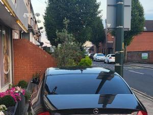 a car parked on the side of a street at Burburry Studio Apartments in Cleethorpes