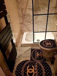 a bathroom with two rugs on the floor and a toilet at Burburry Studio Apartments in Cleethorpes