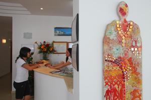 two women standing at a counter in a kitchen at Bikini Hotel in Vieste