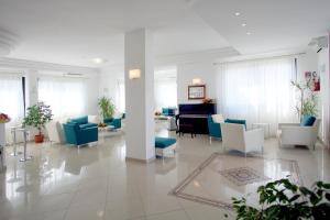 a lobby with chairs and a piano in a building at Bikini Hotel in Vieste