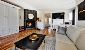 a living room with a couch and a fireplace at 26#52 Chemin du Hameau (studio) in Stoneham