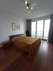 a bedroom with a bed and a large window at Private Apartment Poznań - Free Parking - Netflix in Poznań