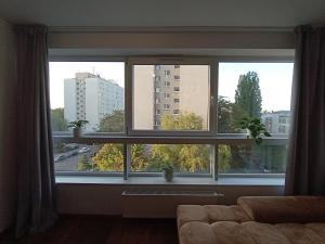 a living room with a window with a view of a city at Private Apartment Poznań - Free Parking - Netflix in Poznań
