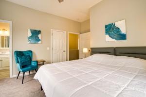 een slaapkamer met een groot bed en een blauwe stoel bij Wilmington Getaway Near Riverwalk and Downtown! in Wilmington