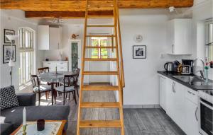 a ladder in a small kitchen with a table at Cozy Home In Svedala With Kitchen in Svedala