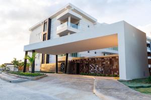 a large white building with a balcony at Cozy condo beach acsess cap cana in Punta Cana