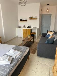 a living room with a bed and a couch at K & G Central Apartments Fira in Fira