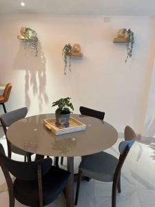 a table with chairs and a potted plant on it at Cozy condo beach acsess cap cana in Punta Cana