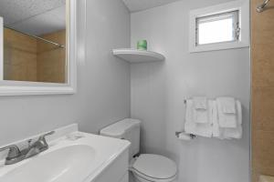 a white bathroom with a toilet and a sink at Mt Royal Motel in Old Orchard Beach
